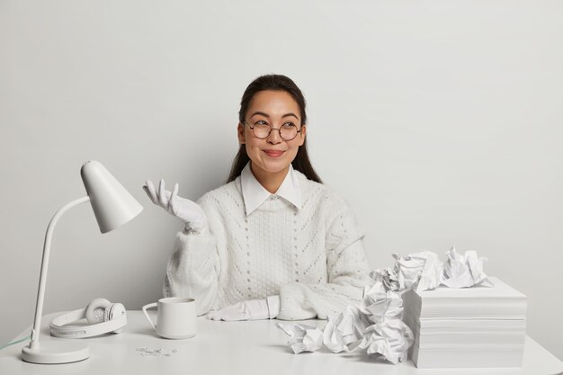 Beautiful young woman studying at her desk