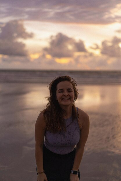 Beautiful young woman at sunset on the ocean, Bali, Indonesia.