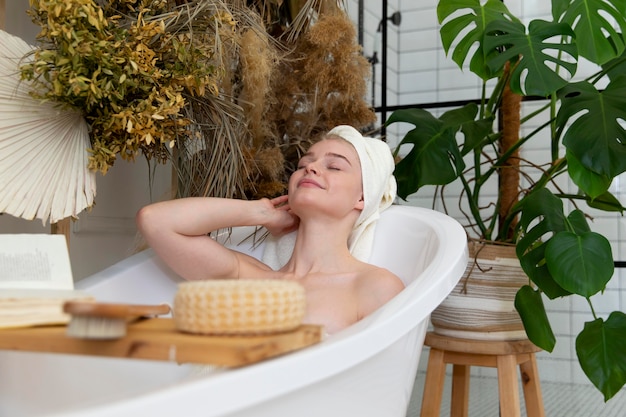 Free photo beautiful young woman taking a bath