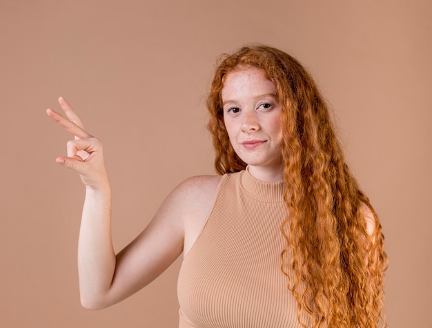 Beautiful young woman teaching sign language