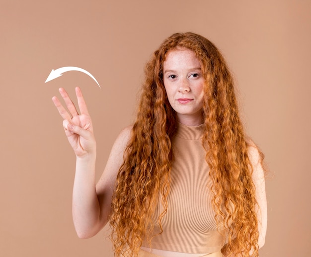 Beautiful young woman teaching sign language