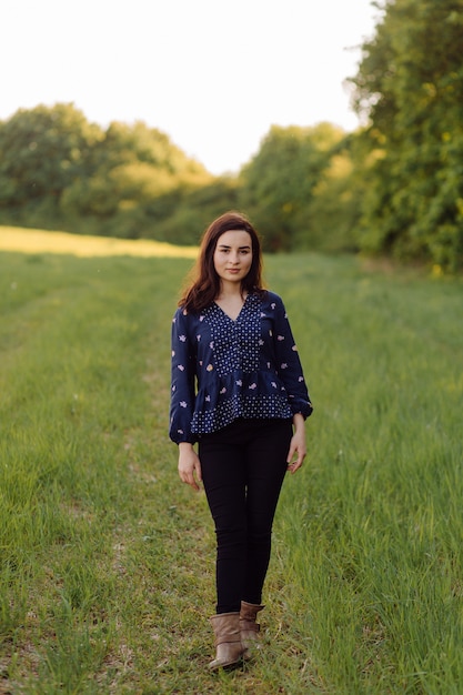 A beautiful young woman walking in the forest