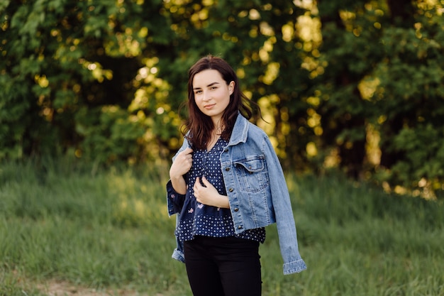 A beautiful young woman walking in the forest