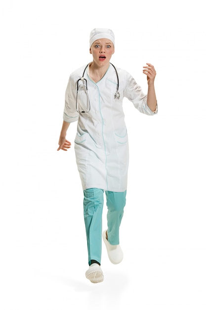 Beautiful young woman in white coat posing at studio. Full length studio shot isolated on white.