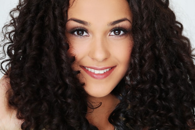 Beautiful young woman with black curly hair