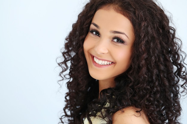 Beautiful young woman with black curly hair