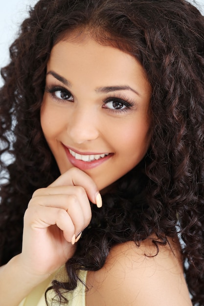 Beautiful young woman with black curly hair