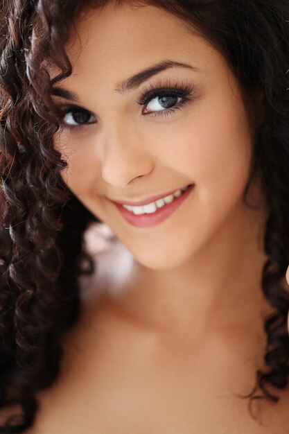 Beautiful young woman with black curly hair