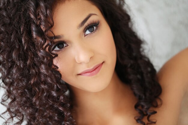 Beautiful young woman with black curly hair