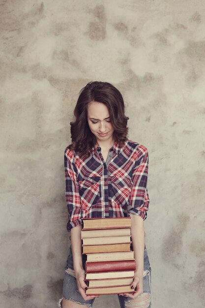 Beautiful young woman with books