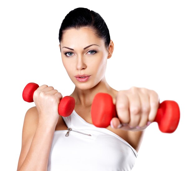 Beautiful young woman with dumbbells