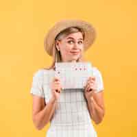 Foto gratuita bella giovane donna con cappello mostrando il calendario dell'ovulazione