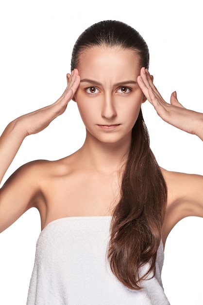 Beautiful young woman with headache touching her temples