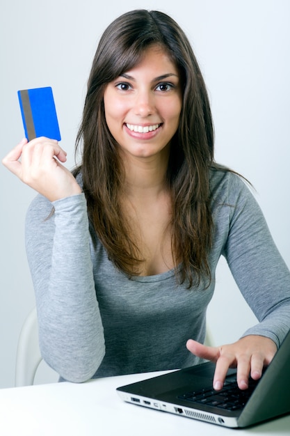 Free photo beautiful young woman with laptop in studio