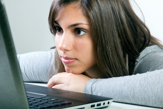 Foto gratuita bella giovane donna con il computer portatile in studio