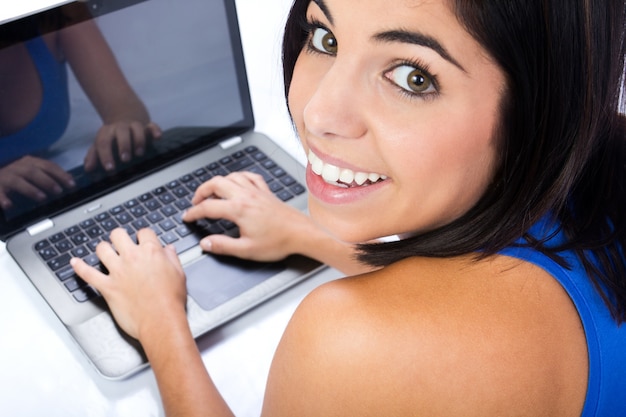 Free photo beautiful young woman with laptop in studio