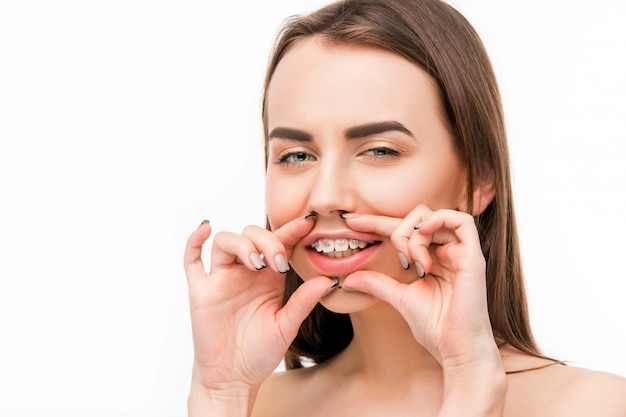 Beautiful young woman with teeth braces