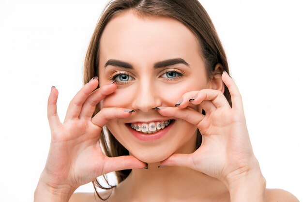 Beautiful young woman with teeth braces