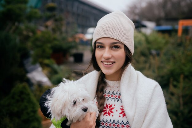 Beautiful young woman with a white dog