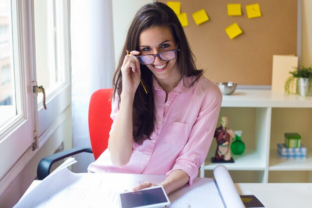 Beautiful young woman working in her office.