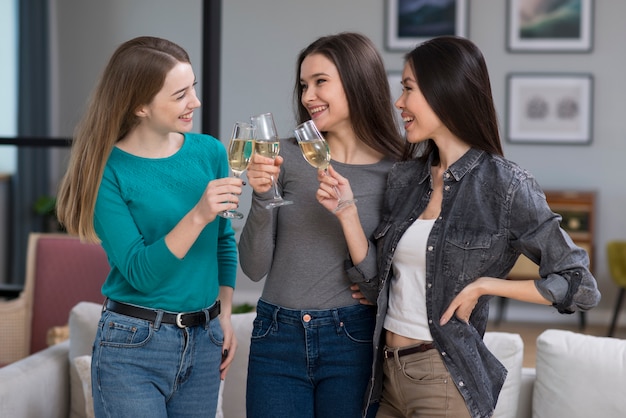 Beautiful young women celebrating with champagne