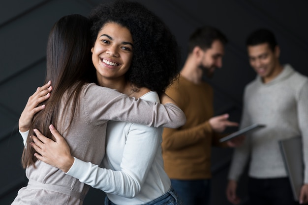 Beautiful young women hugging each other