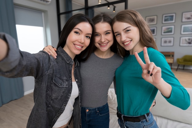 Beautiful young women taking a selfie together