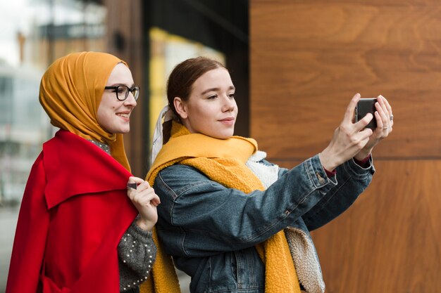 Beautiful young women taking a selfie