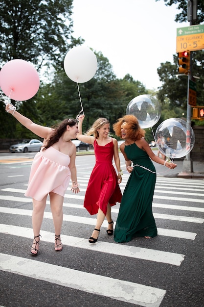 Free photo beautiful young women in their graduation dresses