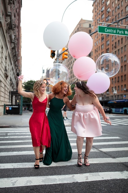 Free photo beautiful young women in their graduation dresses