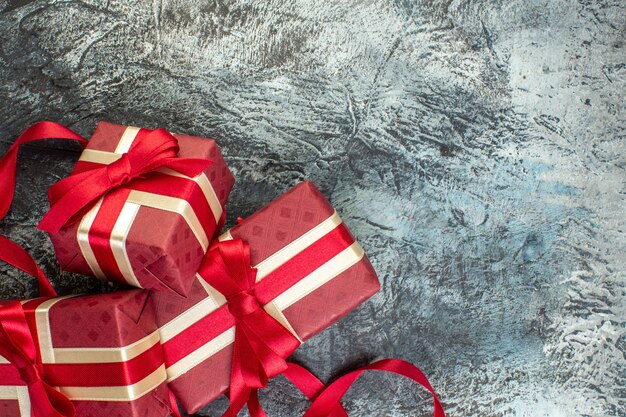 Beautifully packaged gift boxes tied with ribbon on icy dark