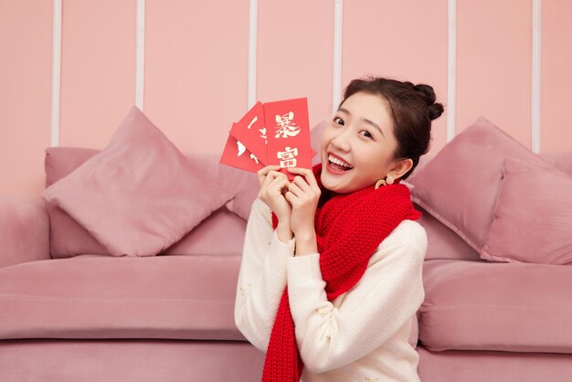 Beauty asian woman celebrates chinese new year red packet