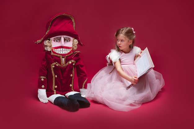 Free photo beauty ballerina sitting with nutcracker