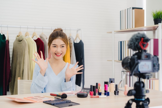 Beauty blogger present beauty cosmetics sitting in front camera for recording video