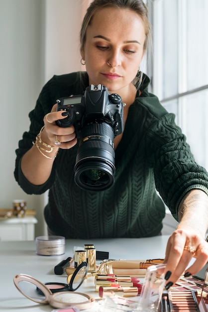 Free photo beauty blogger taking photo of cosmetics