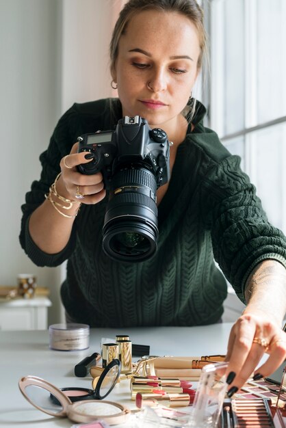 Beauty blogger taking photo of cosmetics