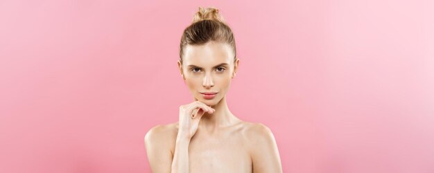 Beauty Concept Beautiful Caucasian woman with clean skin natural makeup isolated on bright pink background with copy space