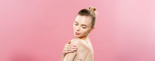 Free photo beauty concept beautiful caucasian woman with clean skin natural makeup isolated on bright pink background with copy space