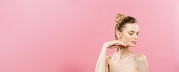 Beauty Concept Beautiful Caucasian woman with clean skin natural makeup isolated on bright pink background with copy space