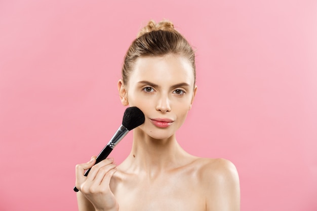 Beauty Concept - Close up Portrait of attractive caucasian girl with beauty natural skin isolated on pink background with copy space. 