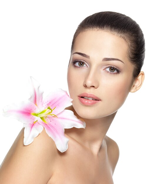 Beauty face of young woman with flower.