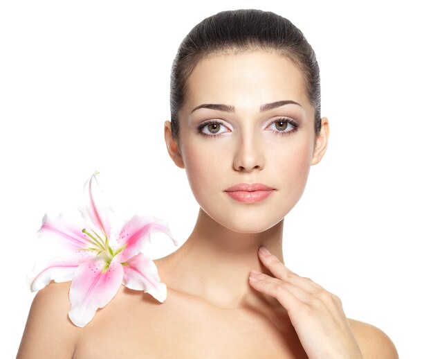 Beauty face of young woman with flower.