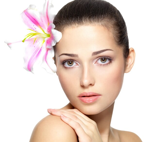 Beauty face of young woman with flower.