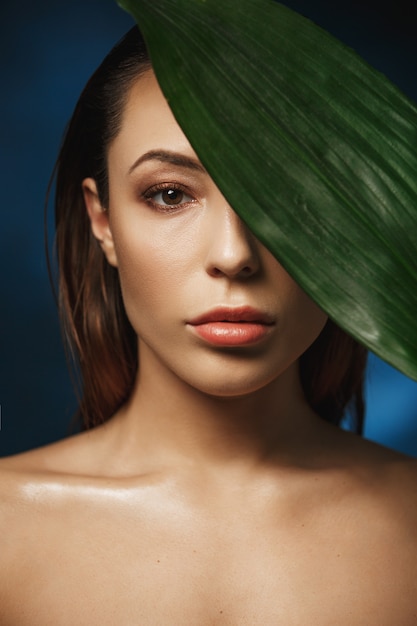 Beauty and fashion photography concept. Naked woman on dark wall