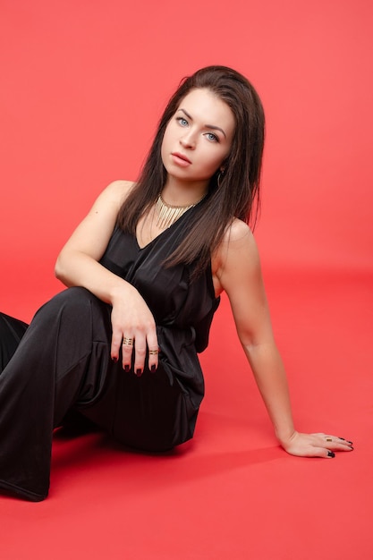 Beauty girl in fashionable black overall and heels