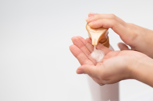 Premium Photo | Beauty and hygiene. female hands pour shampoo to wash their hair.