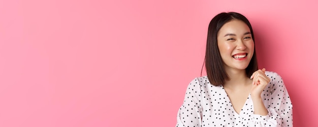 Beauty and lifestyle concept closeup of happy asian female laughing looking happy and showing genuin