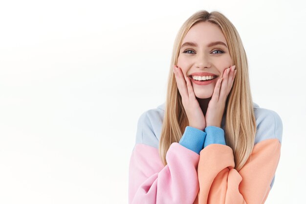 Beauty, lifestyle and fashion concept. Close-up portrait of cheerful, feminine blonde girl in hoodie