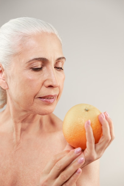 Beauty portrait of an attractive half naked elderly woman