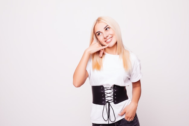 Beauty portrait of blonde woman with call me back gesture on gray back